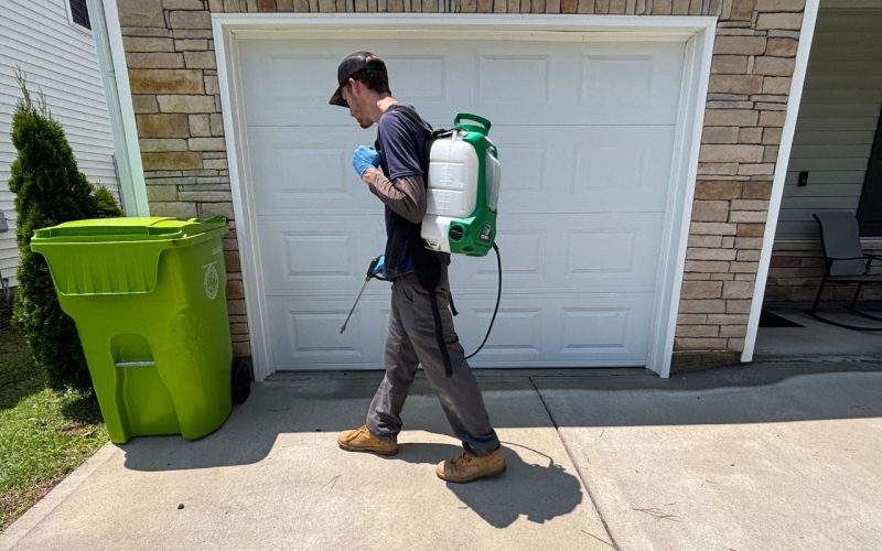 rental-property-management-pest-control-midlands-south-carolina Jeffcoat Tech wearing pest spray backpack spraying pest defense barrier.